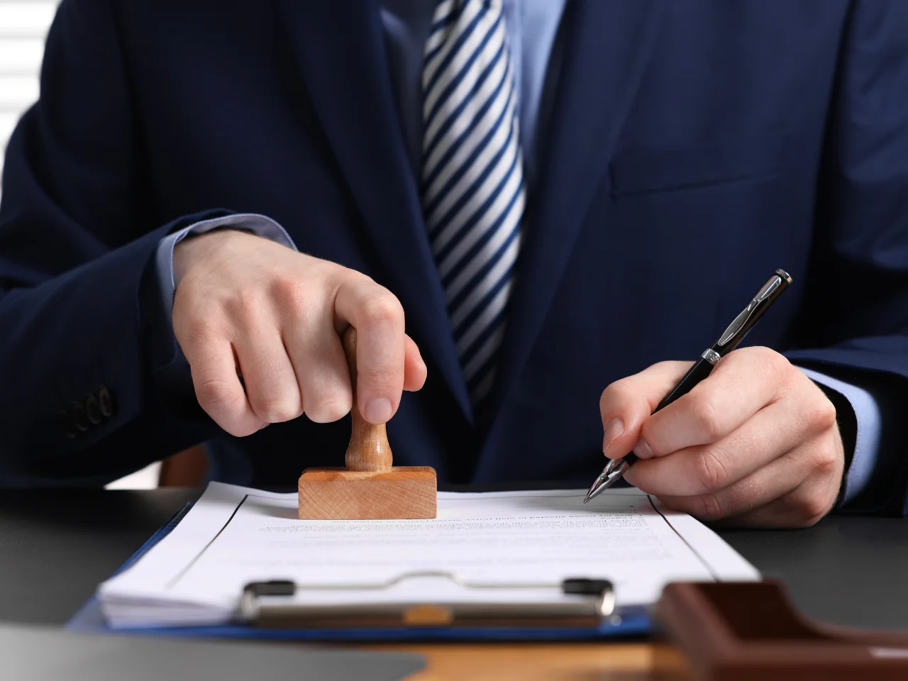 Canadian notary public notarizing and signing a legal document before authentication and attestation.