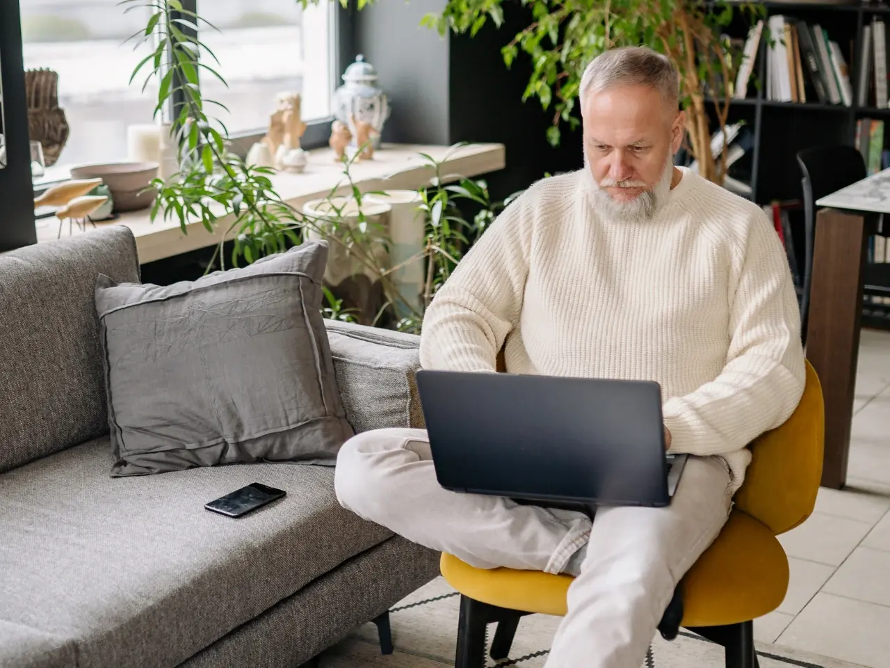 Person using a laptop to view captioned video content.