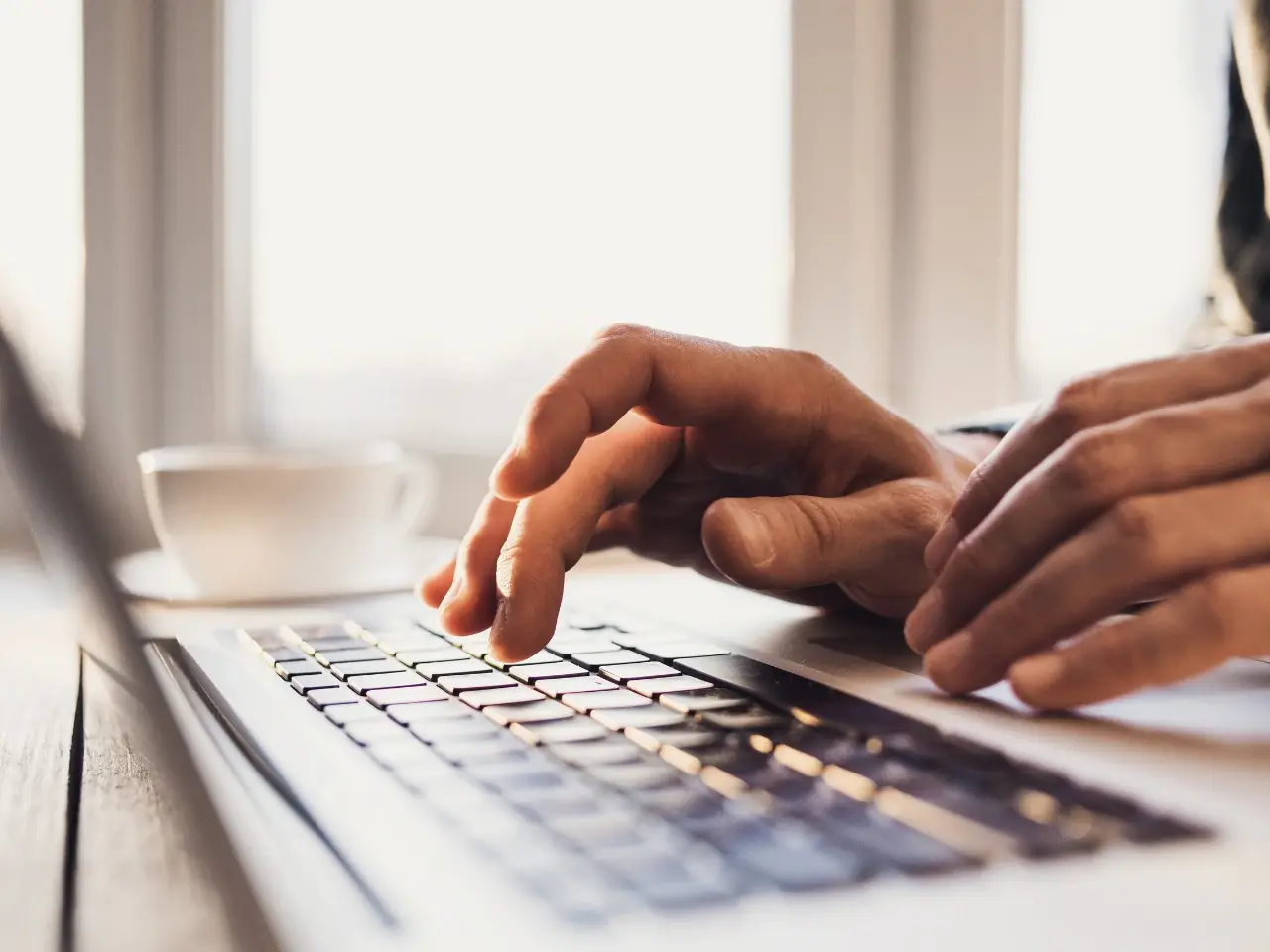 Typing captions or subtitles on a laptop for video content.