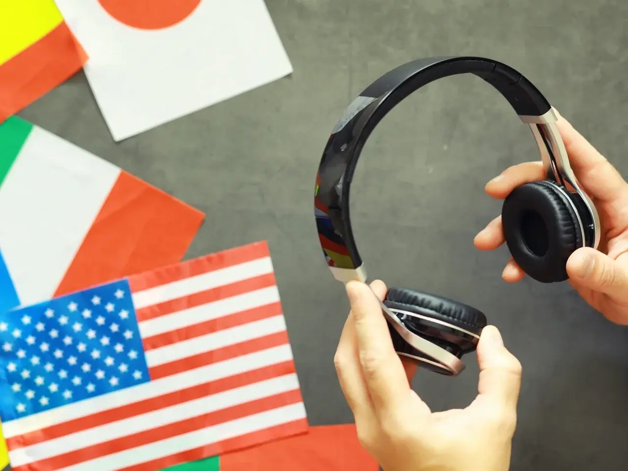 Headphones and flags representing listening to different English accents.