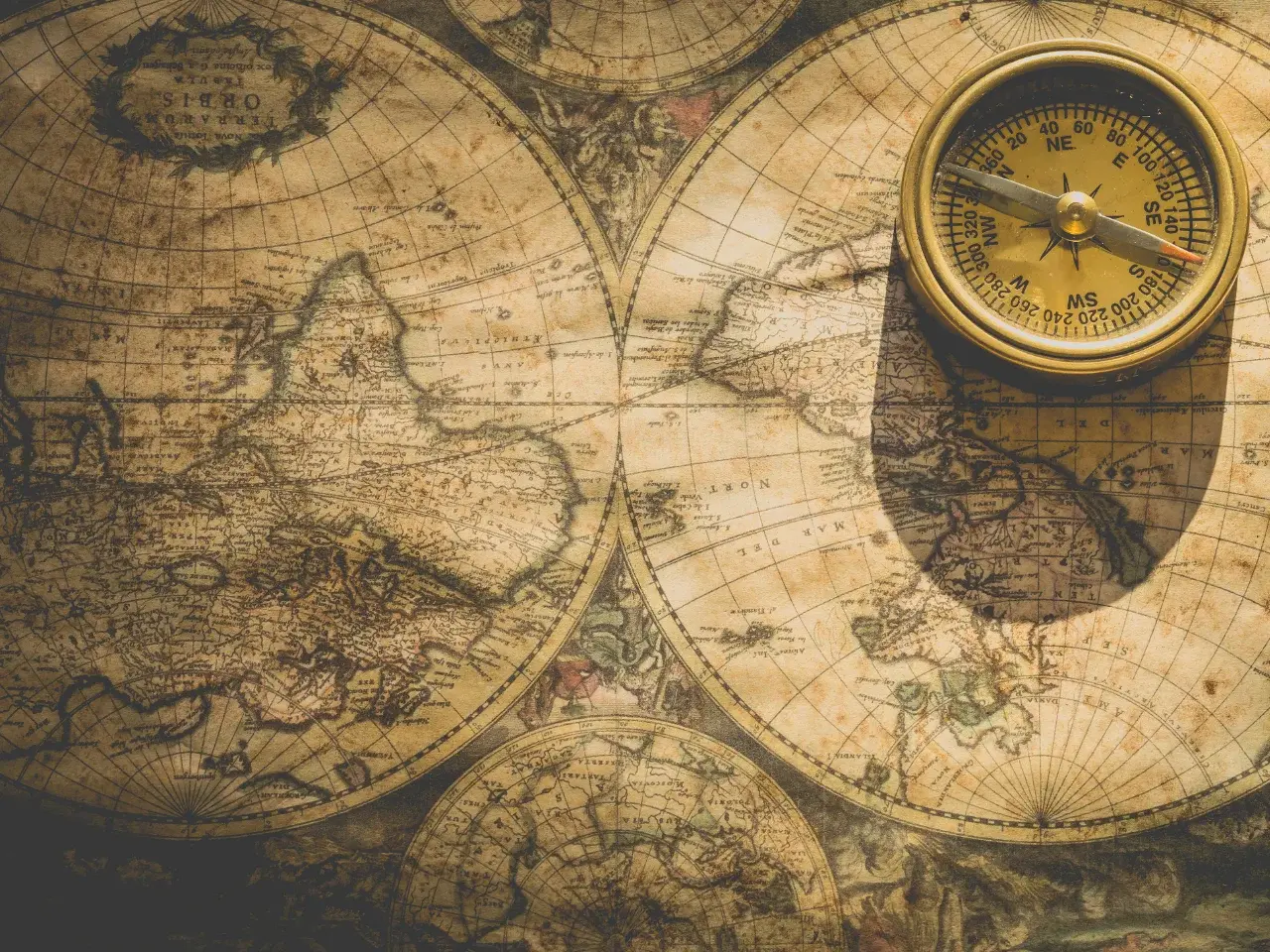 Fantasy map featuring an analog compass on ancient paper.