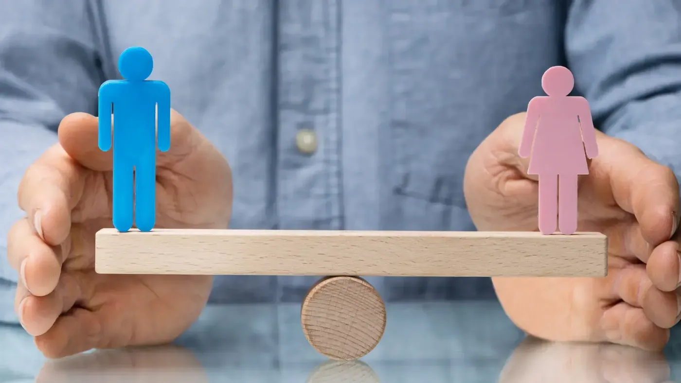 Balance scale showing male and female symbols representing gender concepts.