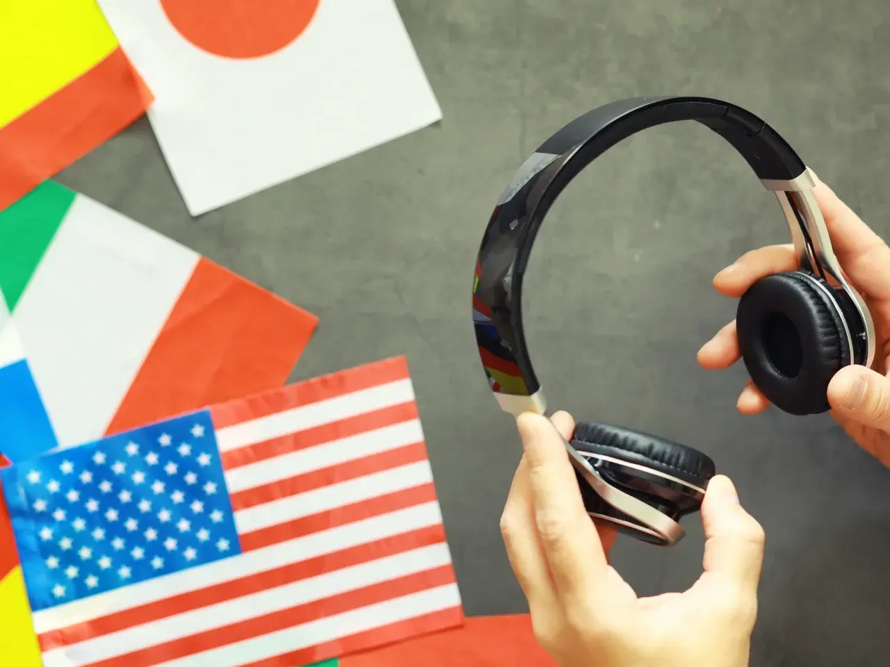 Multiple flags and a headset representing global language testing for Google Translate accuracy rates.