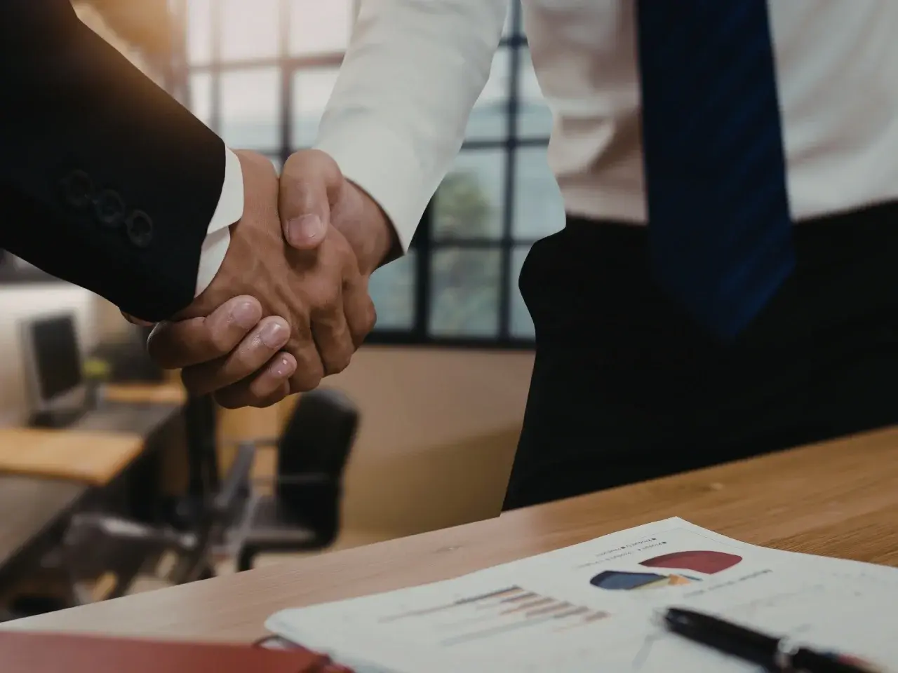 Business handshake representing partnership with a localization company.