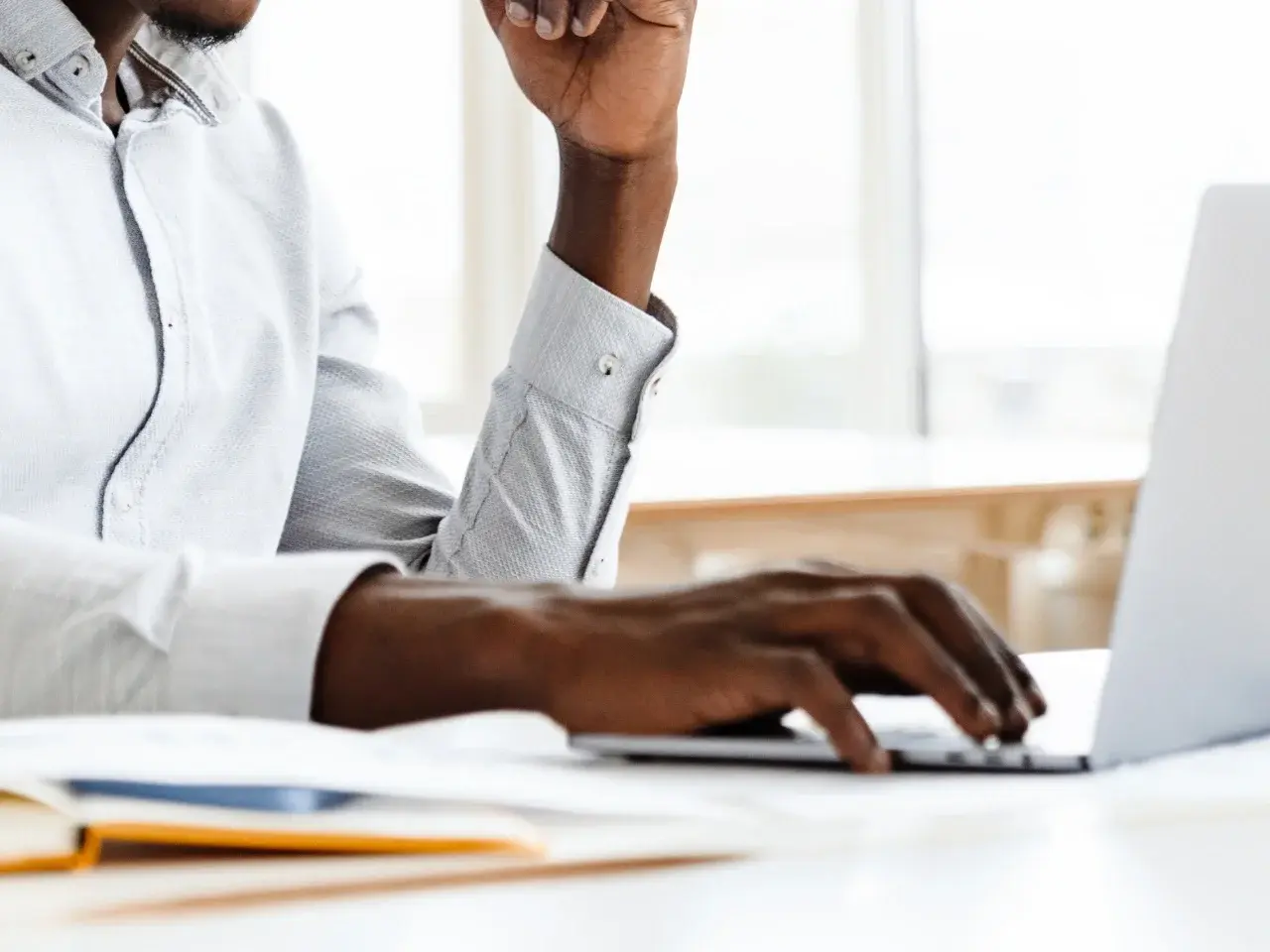 A professional managing translation and localization services on a computer.