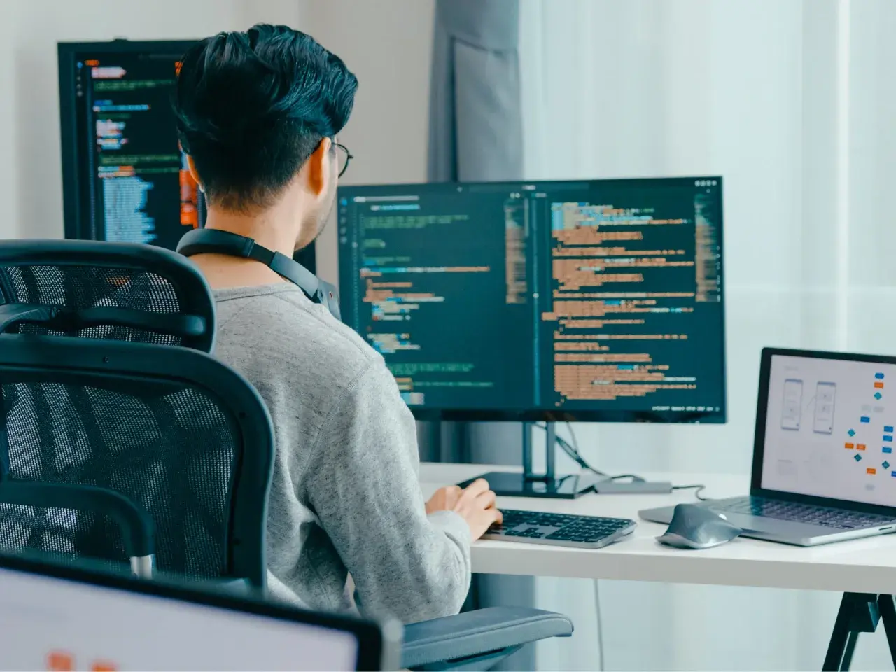 Web developer managing international SEO and language targeting on multiple screens.