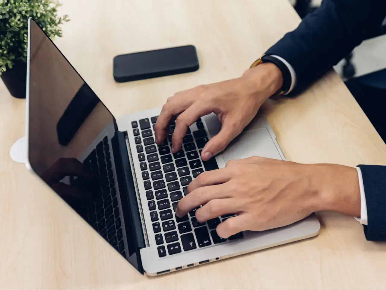 A businessman writing website content on a laptop for AI-supported translation.