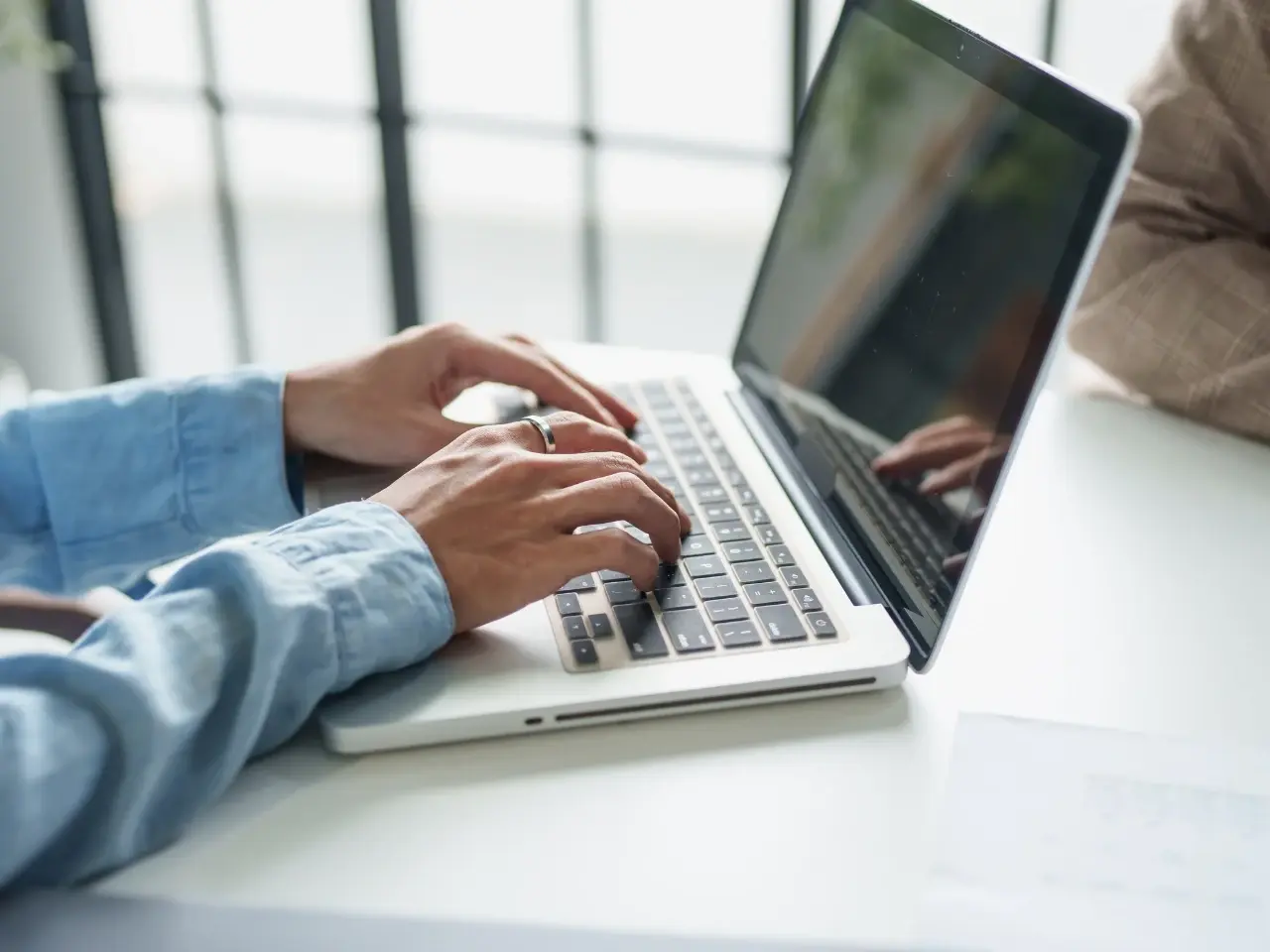 Translator working on a laptop to deliver French translations adapted to regional differences.