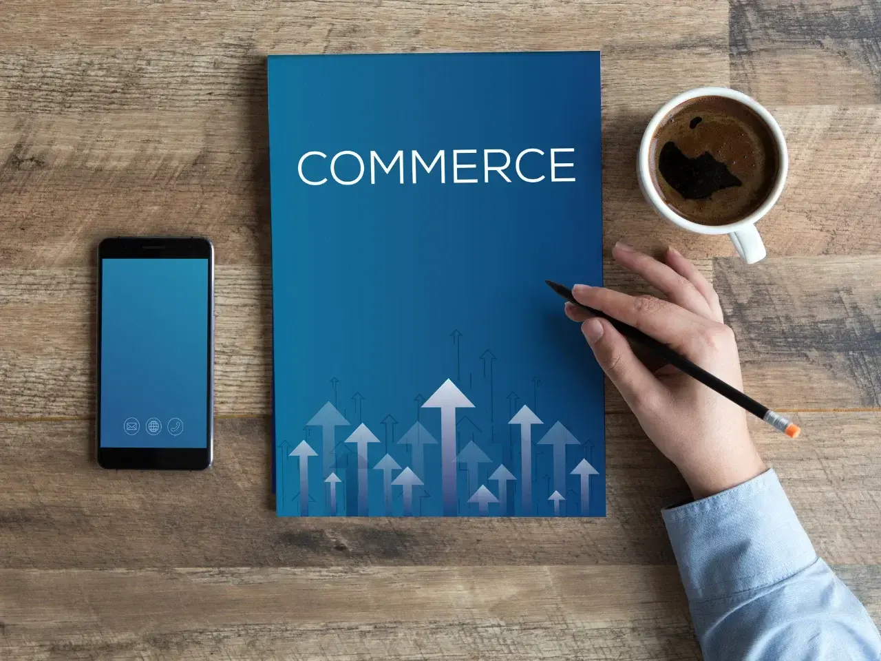 Blue folder with the word ‘Commerce’ on a desk beside a smartphone and a cup of coffee, symbolizing business compliance.