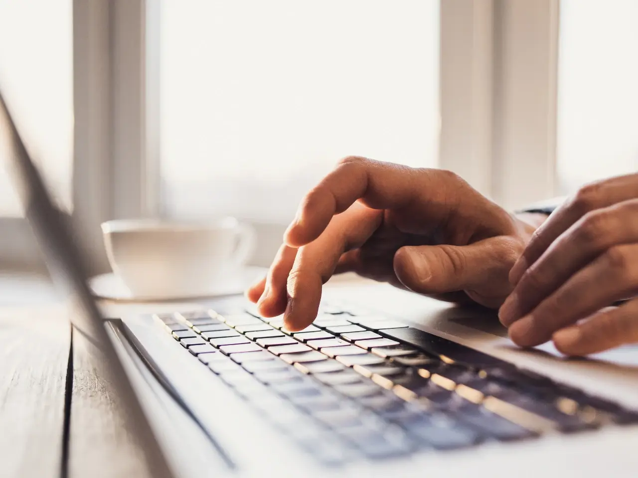 Person typing website content, showing Shopify automatic and manual translation options.