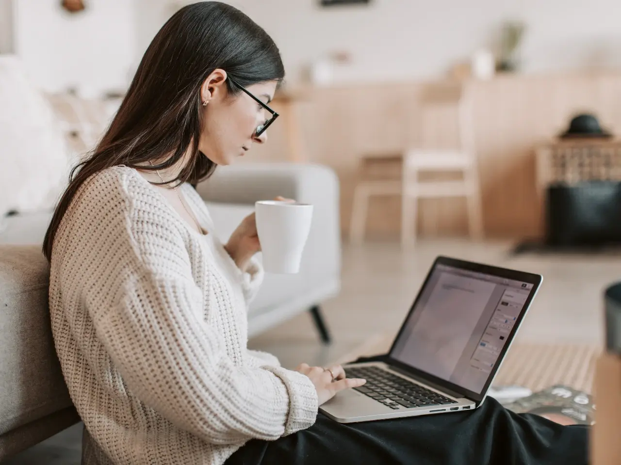 Woman reviewing website text on a laptop, highlighting limitations and unsupported theme or app content.
