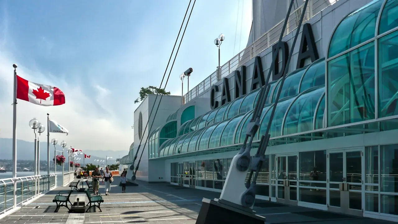 Canadian flag flying at Canada Place symbolizing national identity and the official languages of Canada.