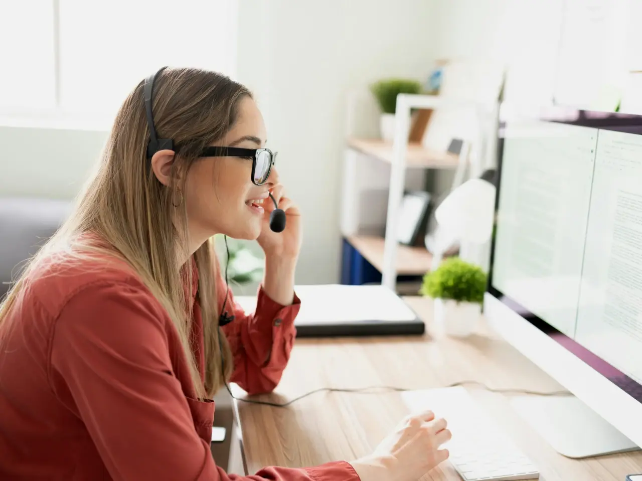 Woman speaking English on a headset representing the most spoken language in Canada.