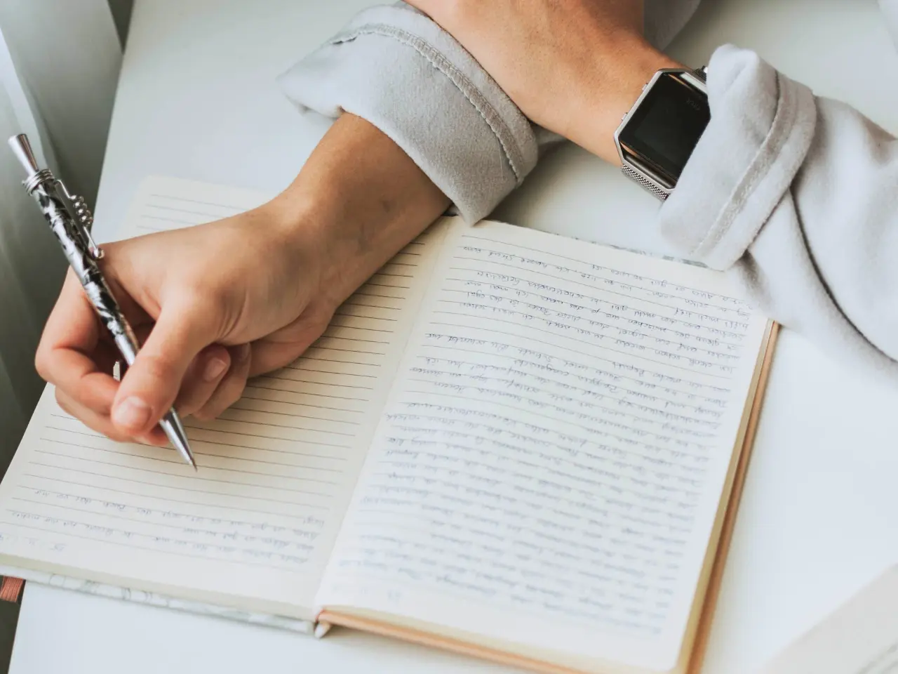 Writing in a notebook while learning translation and linguistics.