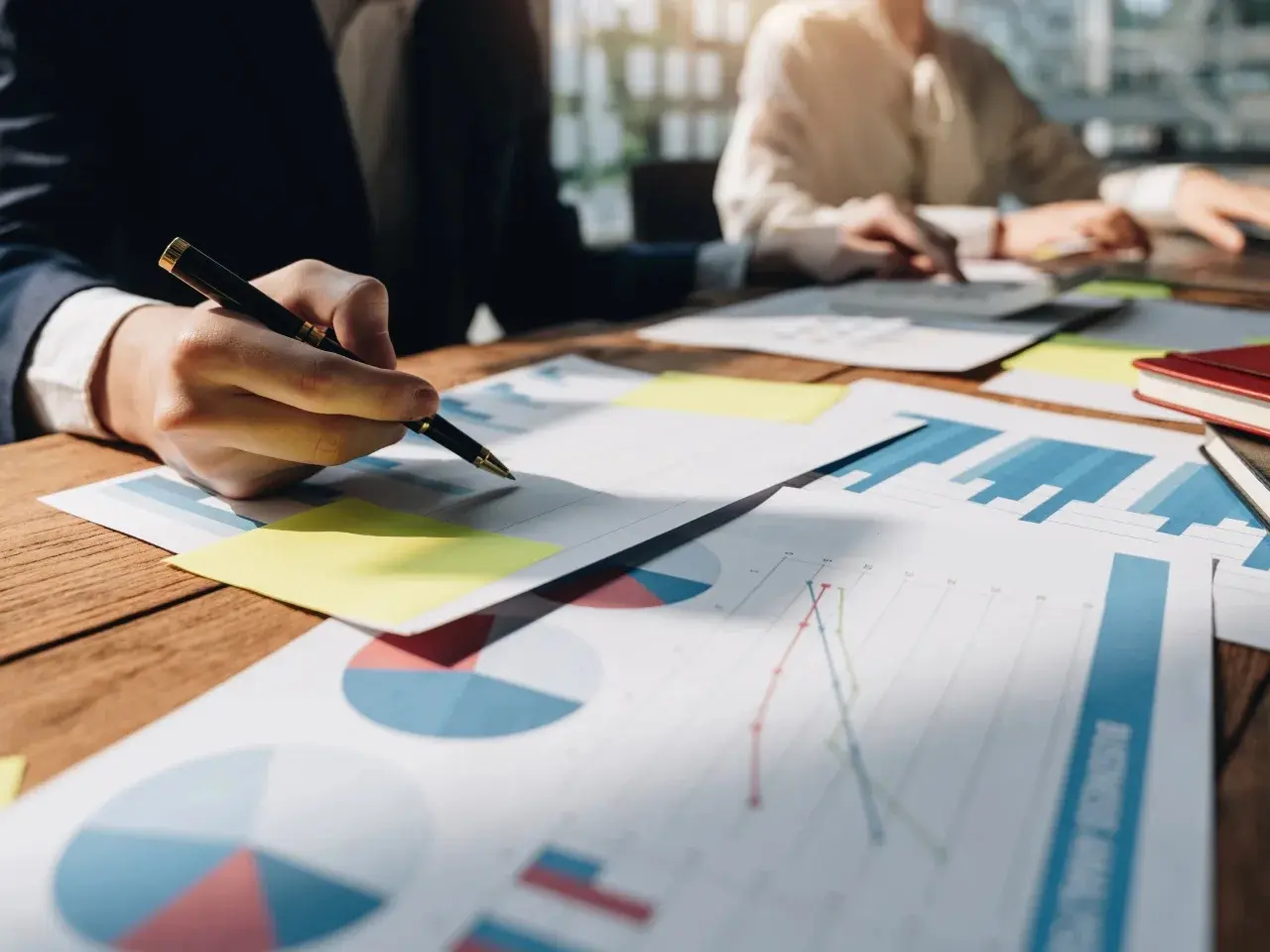 Business professionals analyzing charts and graphs, showing why localization matters for companies.
