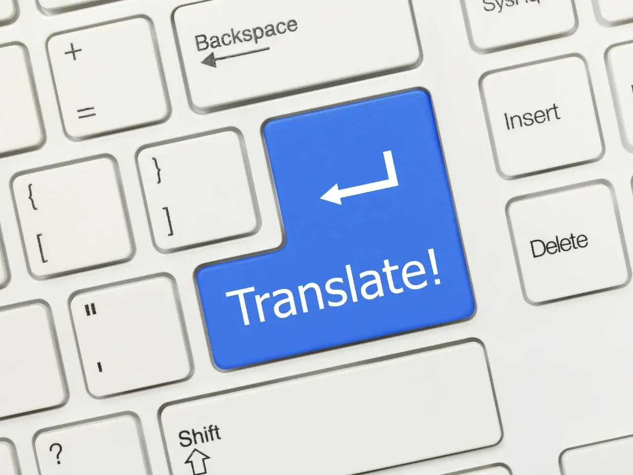 Blue keyboard key with the word “Translate!” symbolizing translation and localization services.
