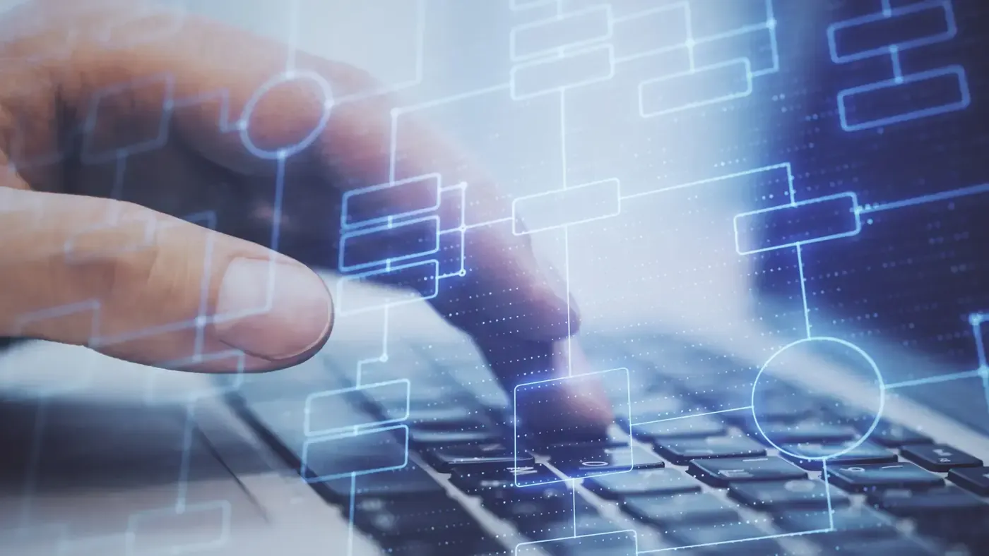 Hands typing on a keyboard representing machine translation before post-editing.