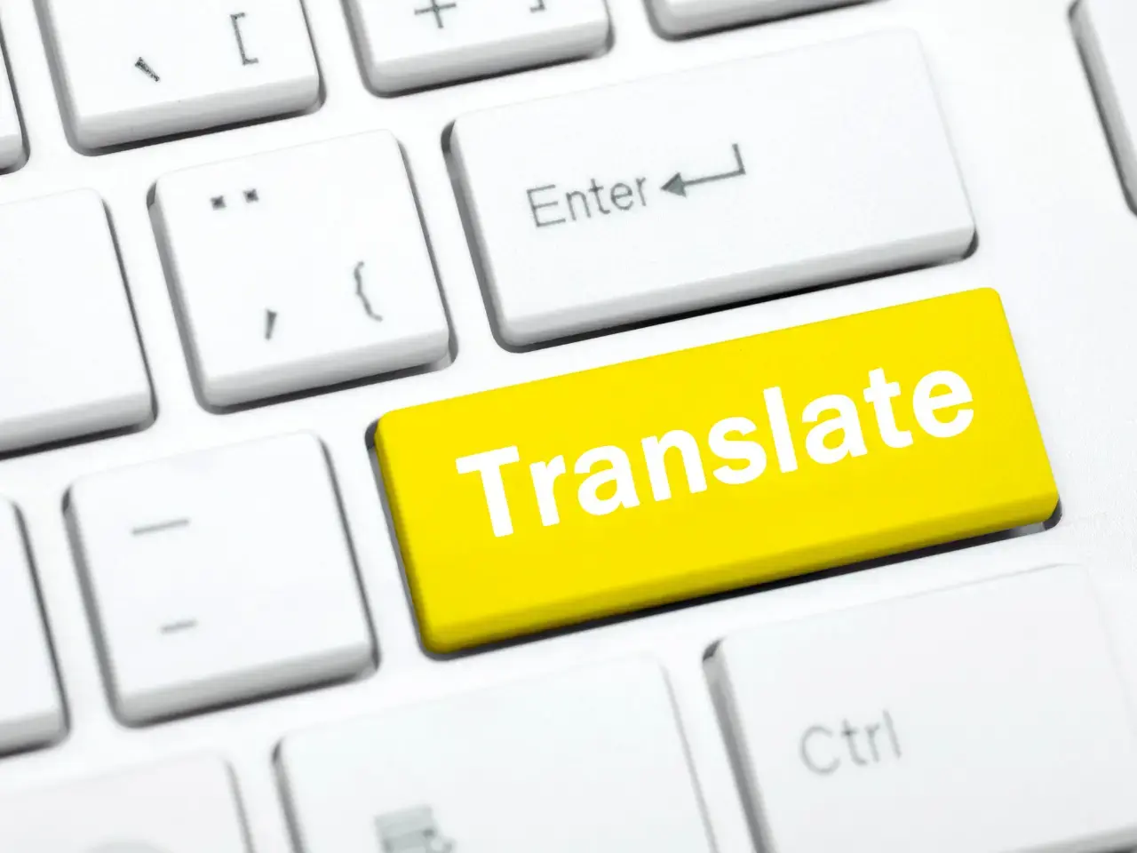 Keyboard with a “Translate” button symbolizing machine translation enhanced through human post-editing.