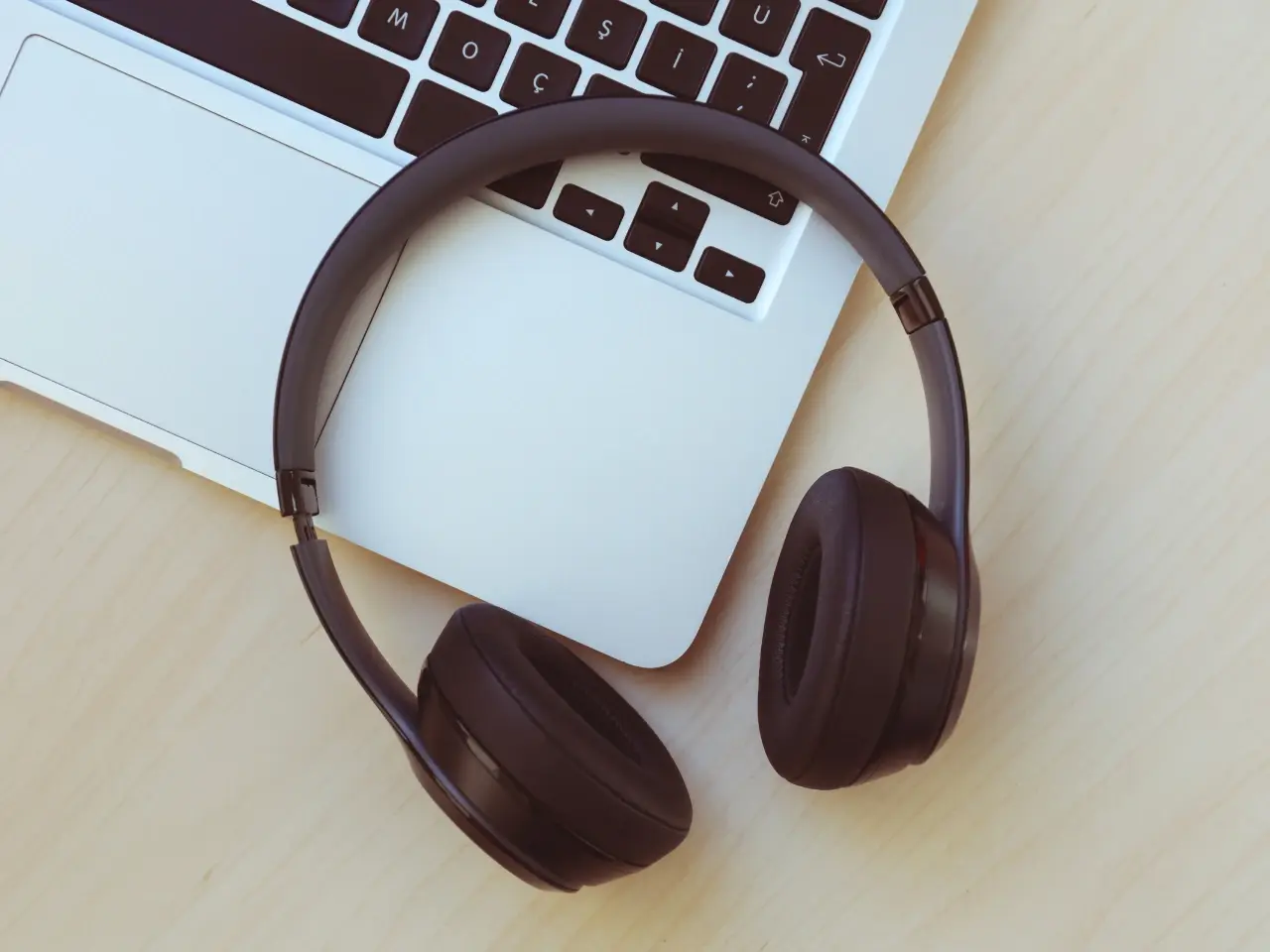 Using headphones and a laptop for audio transcription.