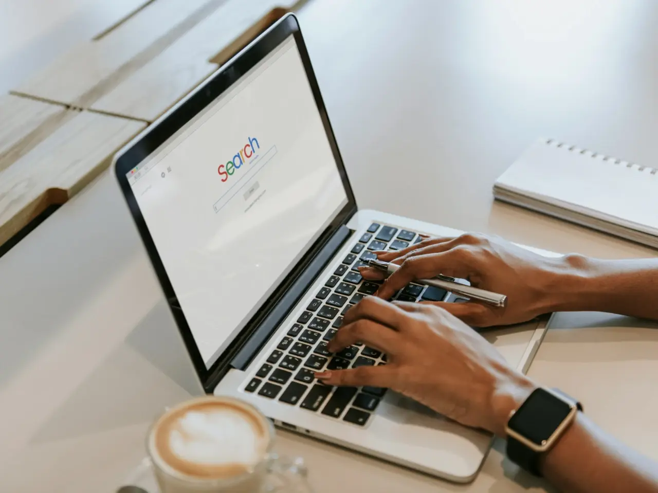 Person using a laptop with a search engine open, representing the search engine market landscape in Canada.