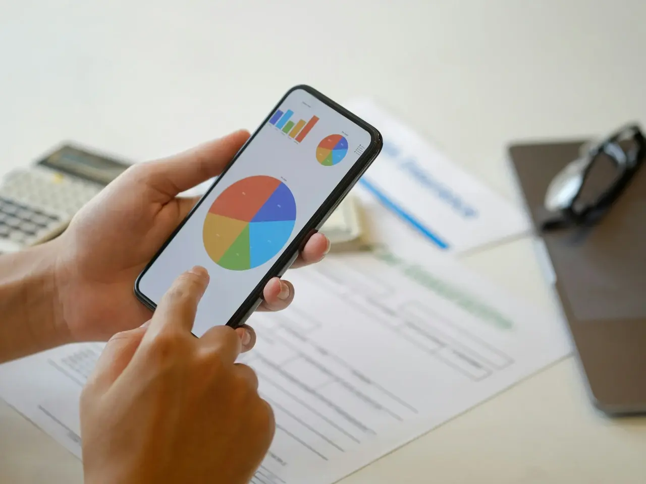 Person analyzing search engine performance charts on a smartphone, illustrating challenges and limitations of alternative search engines in Canada.