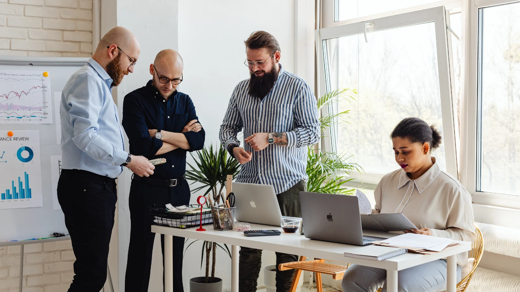 Entrepreneurs reviewing business and financial documents for a Canadian Start-Up Visa.