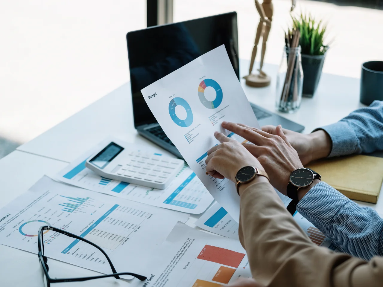 Entrepreneur reviewing financial documents and business budget for Start-Up Visa eligibility.