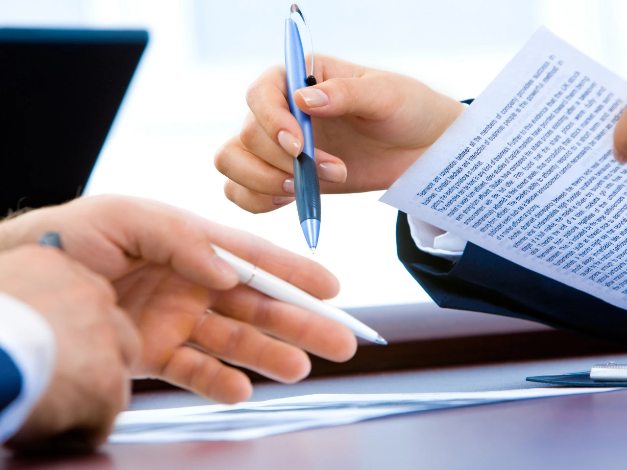 Employer and employee reviewing the terms of an employment agreement.