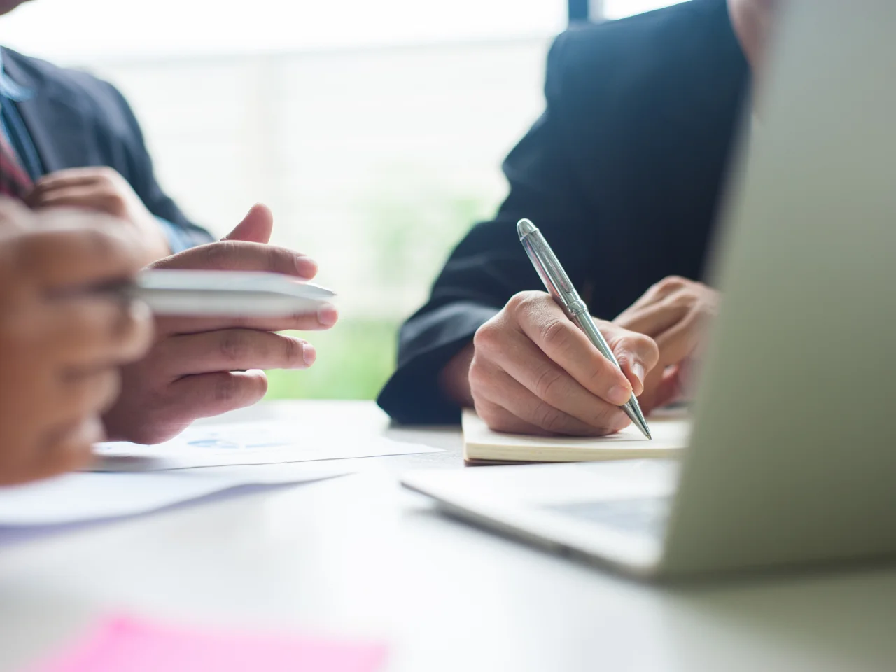 Business professionals completing documents for the GST/HST registration process in Canada.