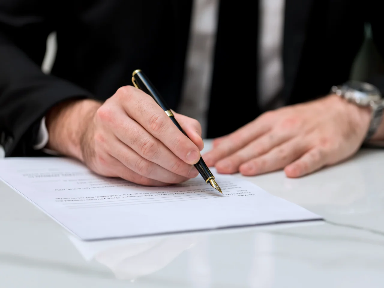 Business professional signing documents for Canadian business registration and corporate requirements.