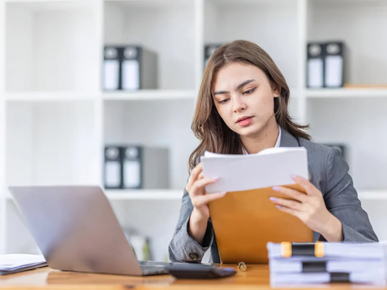 Business professional reviewing documents for a cosmetic notification submission in Canada.