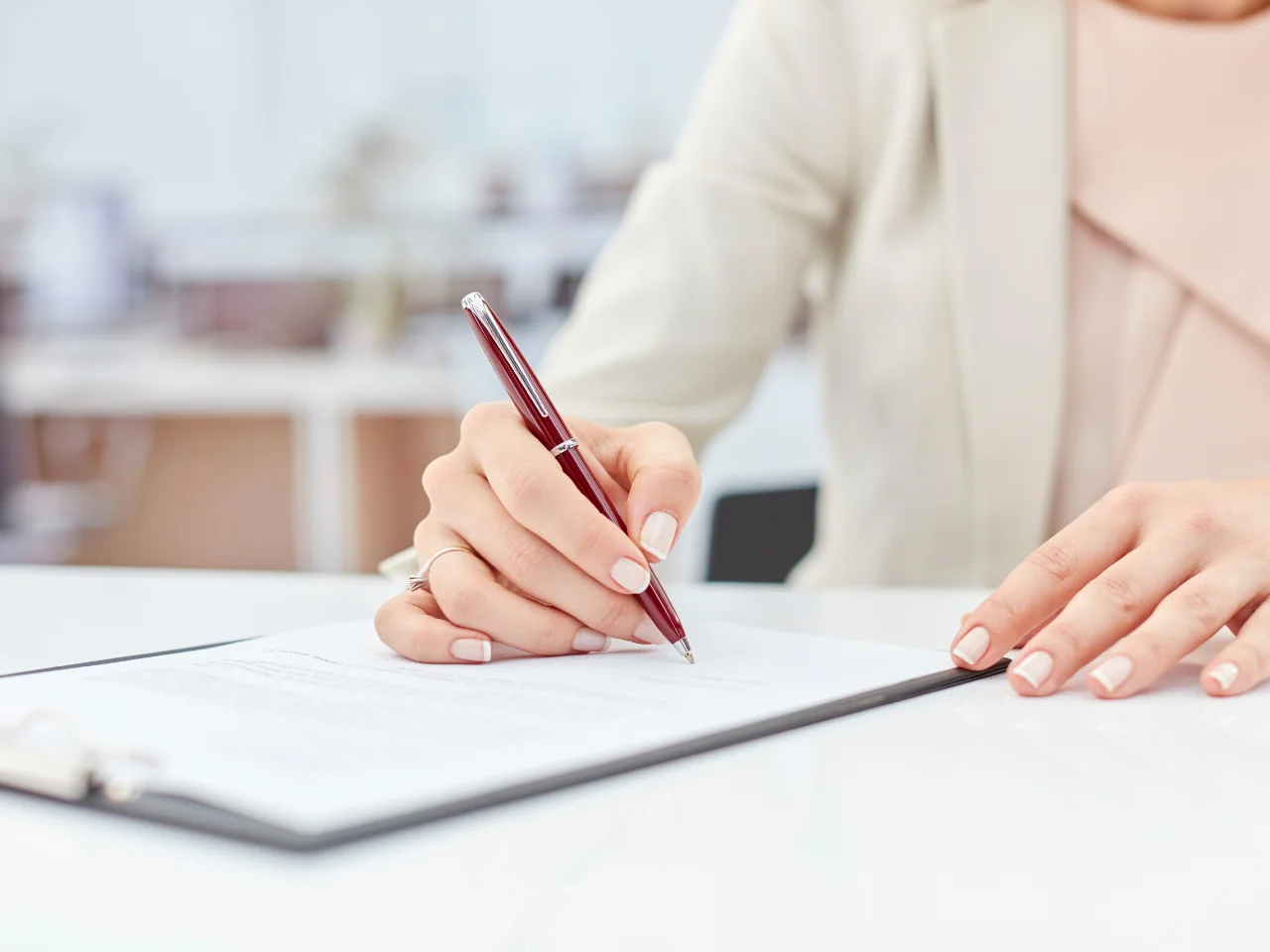 Business professional signing documents for translation, apostille and legalization services.