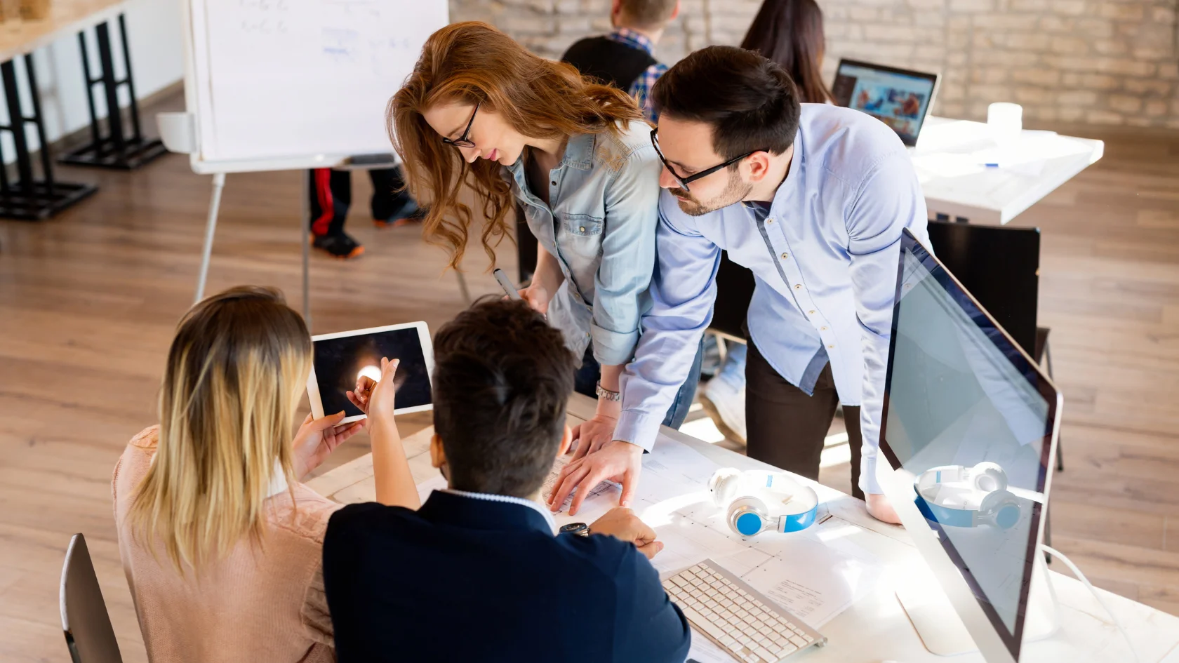 Multinational business team planning an intra company transfer Canada work permit application.
