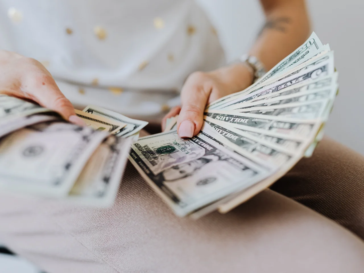 Applicant holding cash as proof of funds for a Canada Express Entry application.