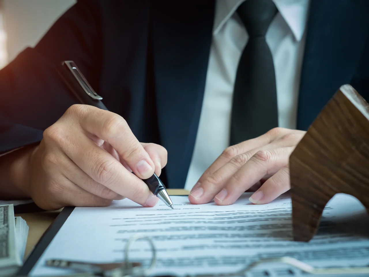 Professional reviewing and signing documents for certified translation and document legalization.