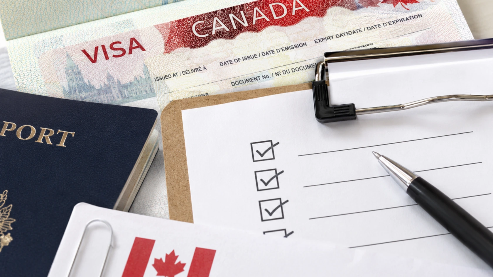 Canada visa and passport with a document checklist for a Spousal Open Work Permit application.