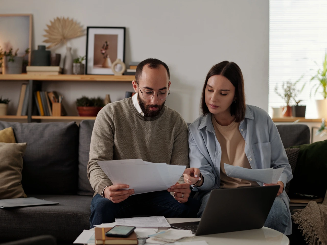 Couple reviewing supporting documents for a Spousal Open Work Permit application.