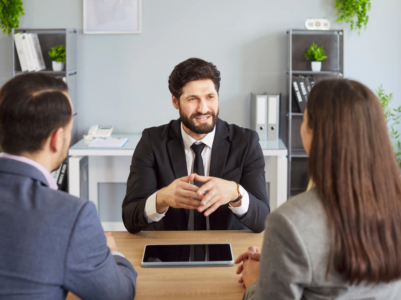 Immigration consultant reviewing Spousal Open Work Permit documents with applicants.