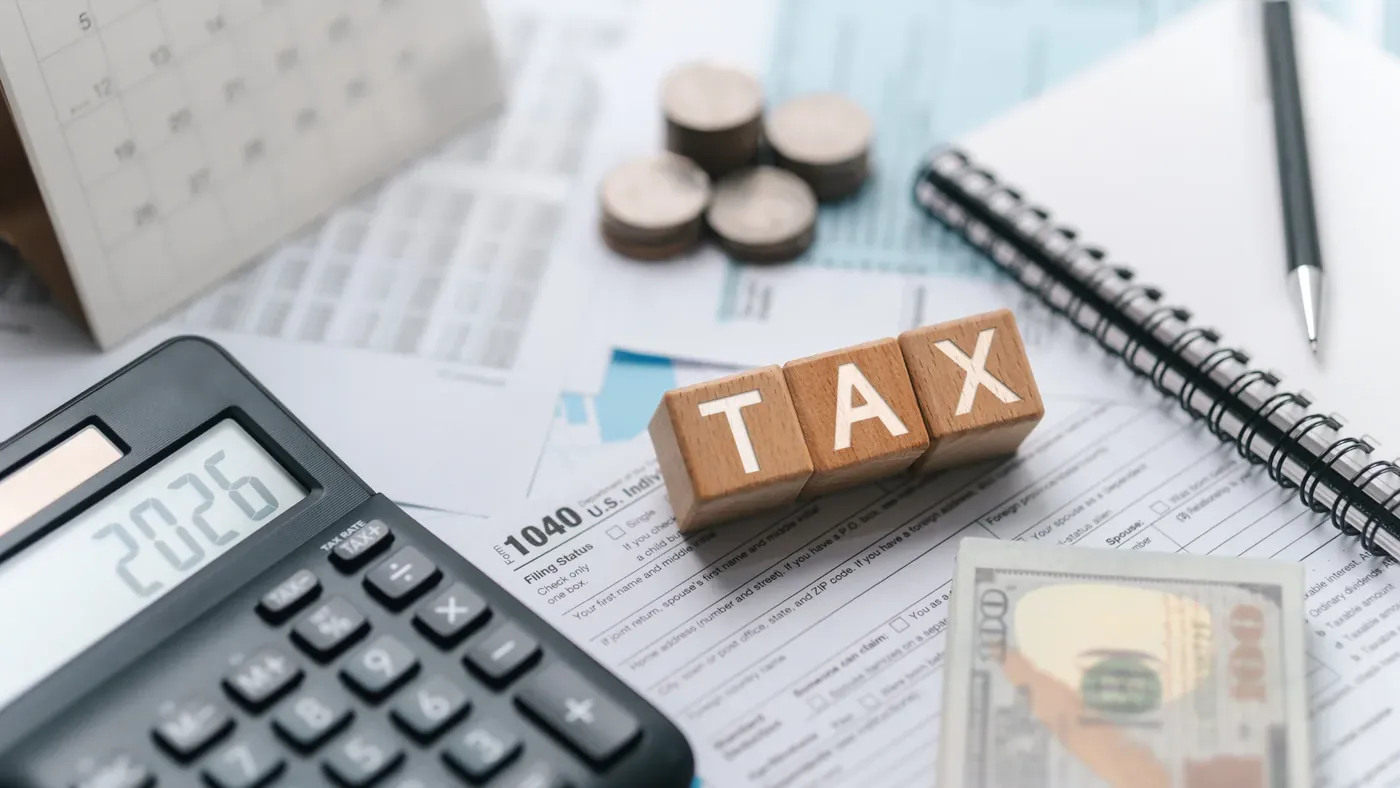 Tax documents, calculator, and financial records representing a tax residency certificate Canada application and CRA tax compliance.