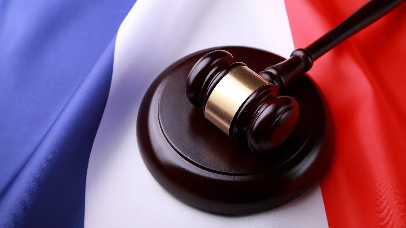 Gavel on French flag representing Quebec language legislation.