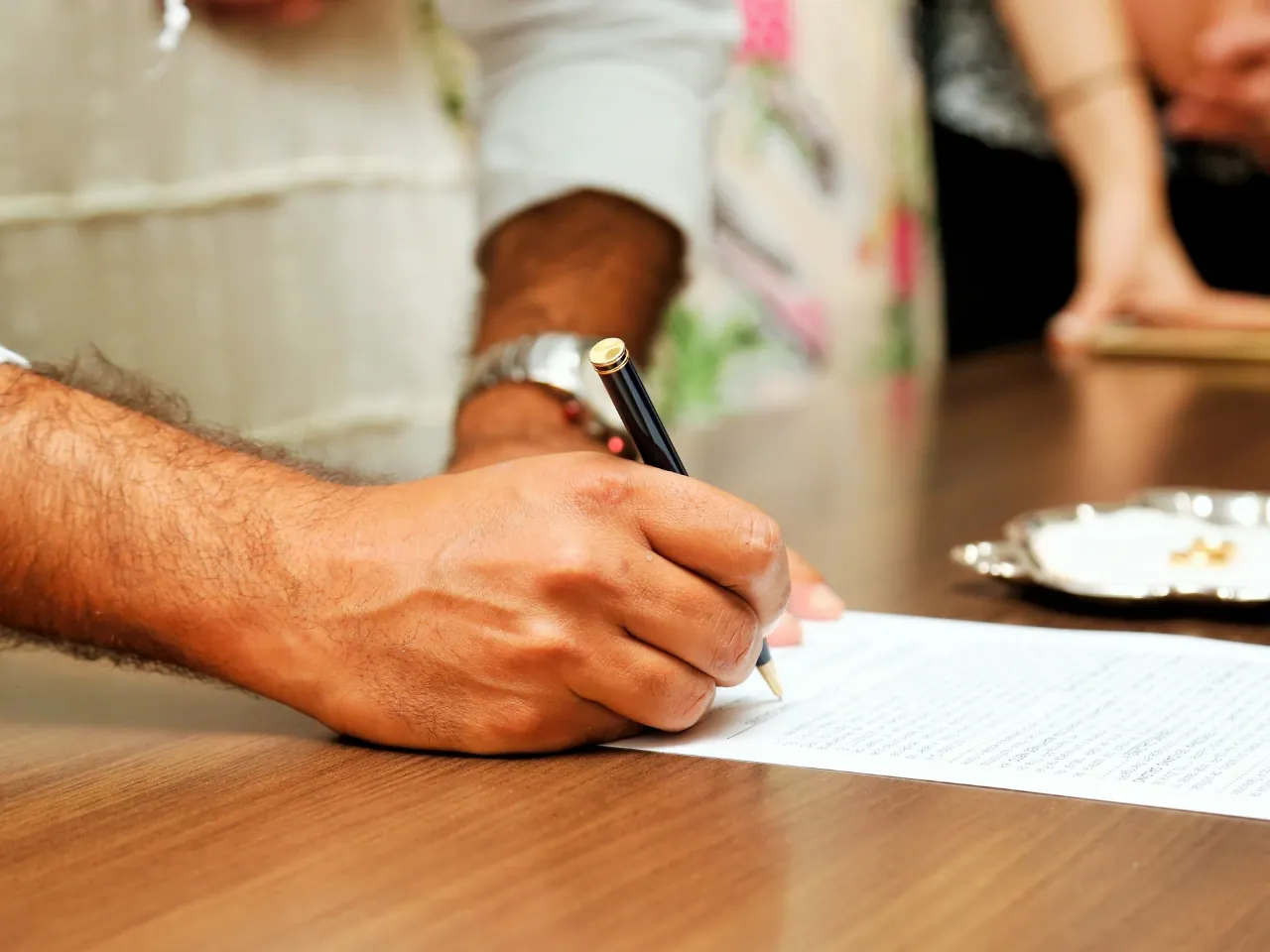Person signing official paperwork for an application requiring supporting documents